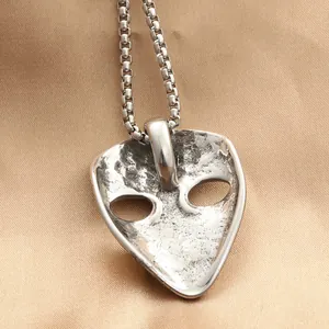 Vintage punk vampire mask pendant in stainless steel with a rustic silver finish