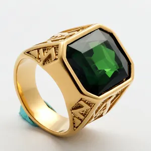 Macro view of a gold-finish titanium steel ring with a large emerald green gemstone