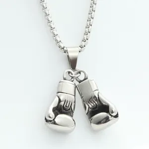 Detailed macro view of polished stainless steel boxing glove pendant with box chain links