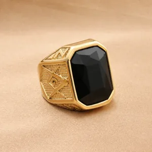 Macro shot of gold-plated signet ring with rectangle black stone and masonic emblem