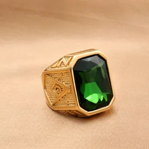 Detail of Masonic gold-plated ring featuring green rectangular gem and side relief