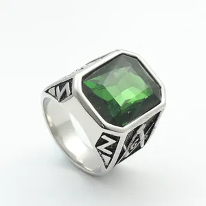 Detailed close-up of a vintage stainless steel ring with a large green gemstone and Masonic logo