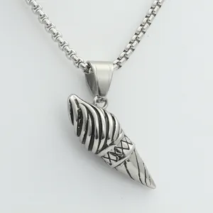 Macro shot of vintage silver ice cream cone pendant with detailed stainless steel textures