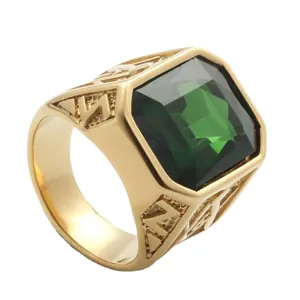 Vintage gold titanium steel ring with emerald-cut green gemstone and geometric cutouts