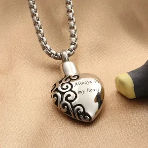 Macro detail of silver heart perfume pendant with Always in my heart engraving
