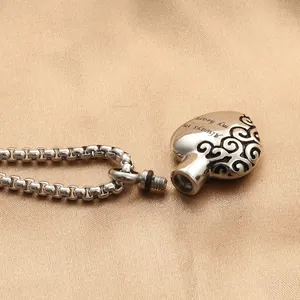 Silver heart urn necklace with Always in my heart engraving on silk fabric background
