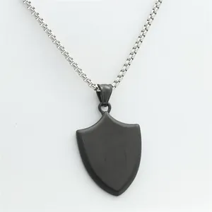 Macro shot of matte black shield pendant with silver venetian chain necklace