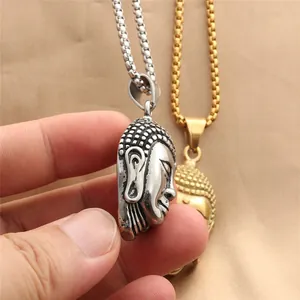 Macro detail of engraved Buddha head pendant in vintage silver and gold stainless steel