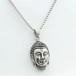 Macro shot of punk retro stainless steel Buddha head pendant with oxidized details