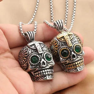 Gothic punk skull pendant in vintage stainless steel with green rhinestones and cross detail