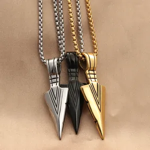 Three punk spearhead pendants in silver black and gold finishes on satin fabric