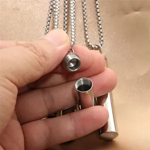 Macro shot showing the screw-top detail and hollow interior of the steel pendant
