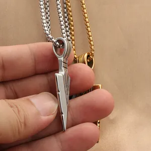 Macro shot of silver and gold punk spearhead pendants on sturdy steel box chains
