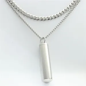 Close-up of double-layered stainless steel necklace with cylinder perfume bottle pendant