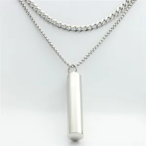 Detail of silver stainless steel double layer chain necklace with cylindrical pendant