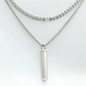 Detailed view of silver stainless steel capsule pendant with dual layered cuban and box chains
