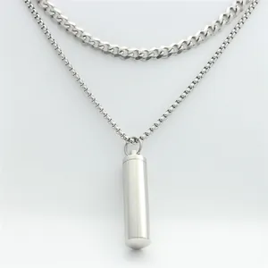 Close-up of double-layered stainless steel chain with a cylindrical capsule pendant