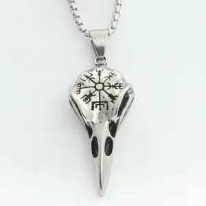 Macro detail of viking raven skull pendant with vegvisir rune in aged stainless steel