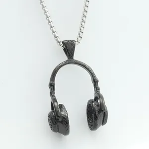 Macro detail of a black textured headphone pendant with a silver box chain necklace