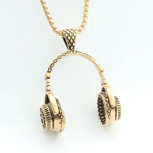 Detailed close-up of antique gold headphone pendant with intricate diamond textures