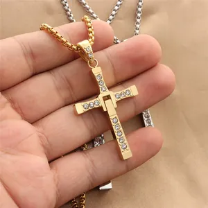 Macro view of gold cross pendant with crystal rhinestones and articulated movable joints
