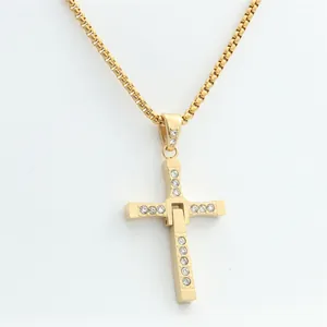 Detailed view of gold-plated mechanical cross pendant with sparkling rhinestones and box chain