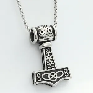 Close-up of vintage Thor's hammer pendant with Nordic runes and celtic knot details