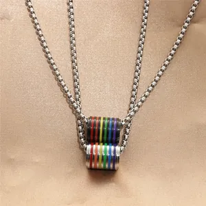 Detail of stainless steel box chains with rainbow stripe cylindrical pride pendants