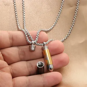 Bullet-shaped stainless steel pendant necklace with gold accents and paw print engraving