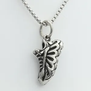 Detailed view of a retro silver punk sneaker pendant with a sturdy metal box chain necklace