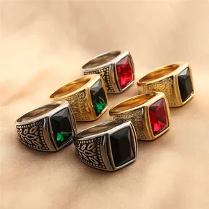 Close-up of vintage titanium steel rings with assorted rectangular gemstones on satin