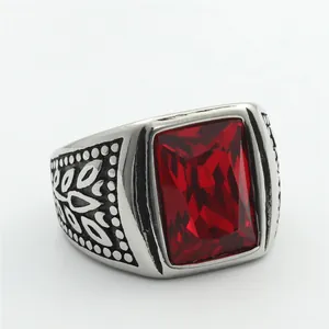 Macro shot of rectangular red gemstone set in a silver-tone carved stainless steel ring