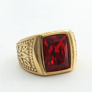 Macro shot of rectangular red gemstone on a golden stainless steel ring with leaf relief