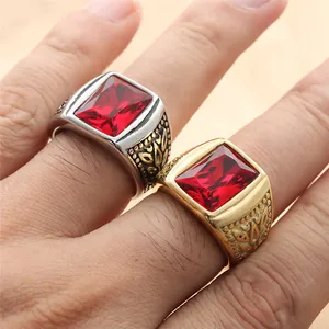 Macro shot of vintage titanium steel rings with large red rectangular gemstones and relief
