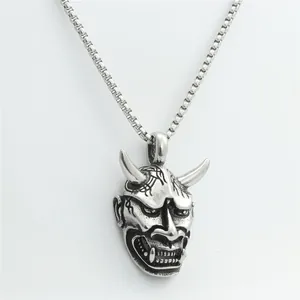 Detailed view of punk style stainless steel Hannya skull mask pendant on a box chain