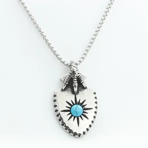 Macro view of vintage shield pendant with eagle claw and turquoise stone detail