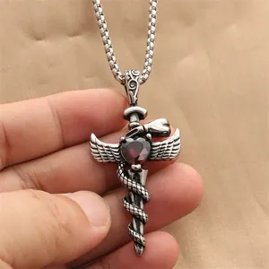Gothic sword necklace with silver wings, coiled snake and red heart gemstone