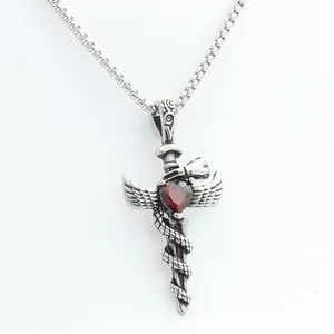 Detailed close-up of a silver sword pendant with red heart gemstone and wing motifs