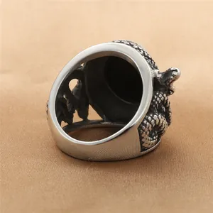 Vintage stainless steel snake ring with black stone and dragon relief carving