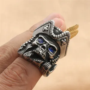Retro punk pirate skull ring in stainless steel with blue zircon eyes and gold feather detail