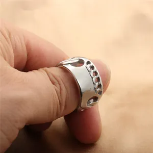Macro shot of silver titanium steel chain ring with vintage punk texture details