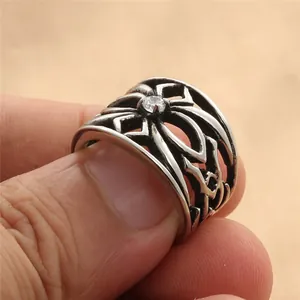 Detailed close-up of retro gothic hollow ring with black oxidized finish and zircon