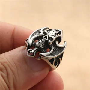 Close-up of retro punk skull and bat wing ring with vintage oxidized steel finish