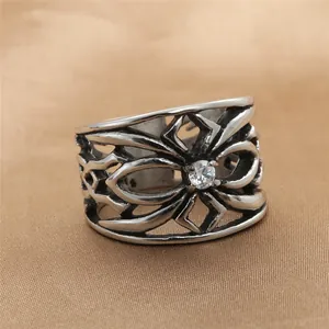 Macro shot of punk style stainless steel hollow flower ring with central zircon stone