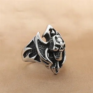 Detailed close-up of retro stainless steel skull ring with punk bat wing engravings