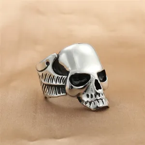 Macro shot of 3D punk skull ring in vintage silver finish on satin fabric background