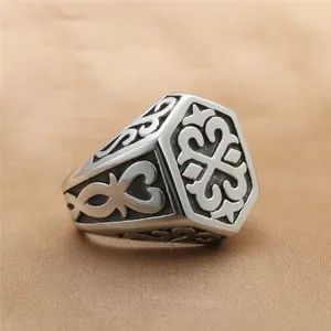 Macro detail of hexagonal stainless steel ring featuring vintage totem engraving