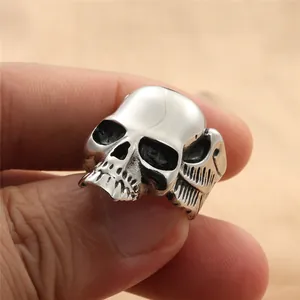 Macro view of vintage punk skull ring featuring detailed wing textures and silver finish