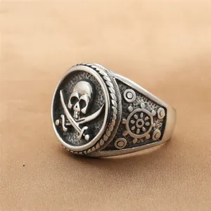 Macro detail of retro stainless steel pirate ring with skull, cross swords and helm