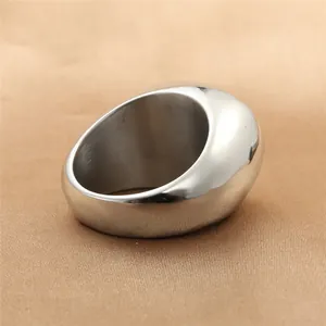 Anillo abombado de plata con acabado ovalado pulido sobre fondo de seda de color marrón